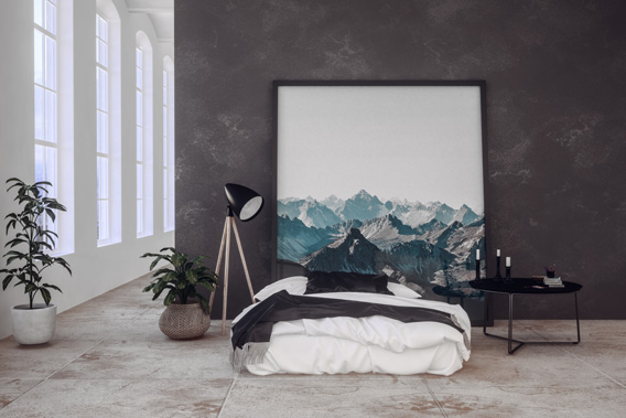 a bed with a picture on the wall